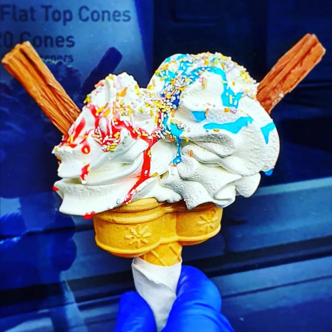Massive twin cone with double flakes, rainbow sprinkles and red & blue sauces