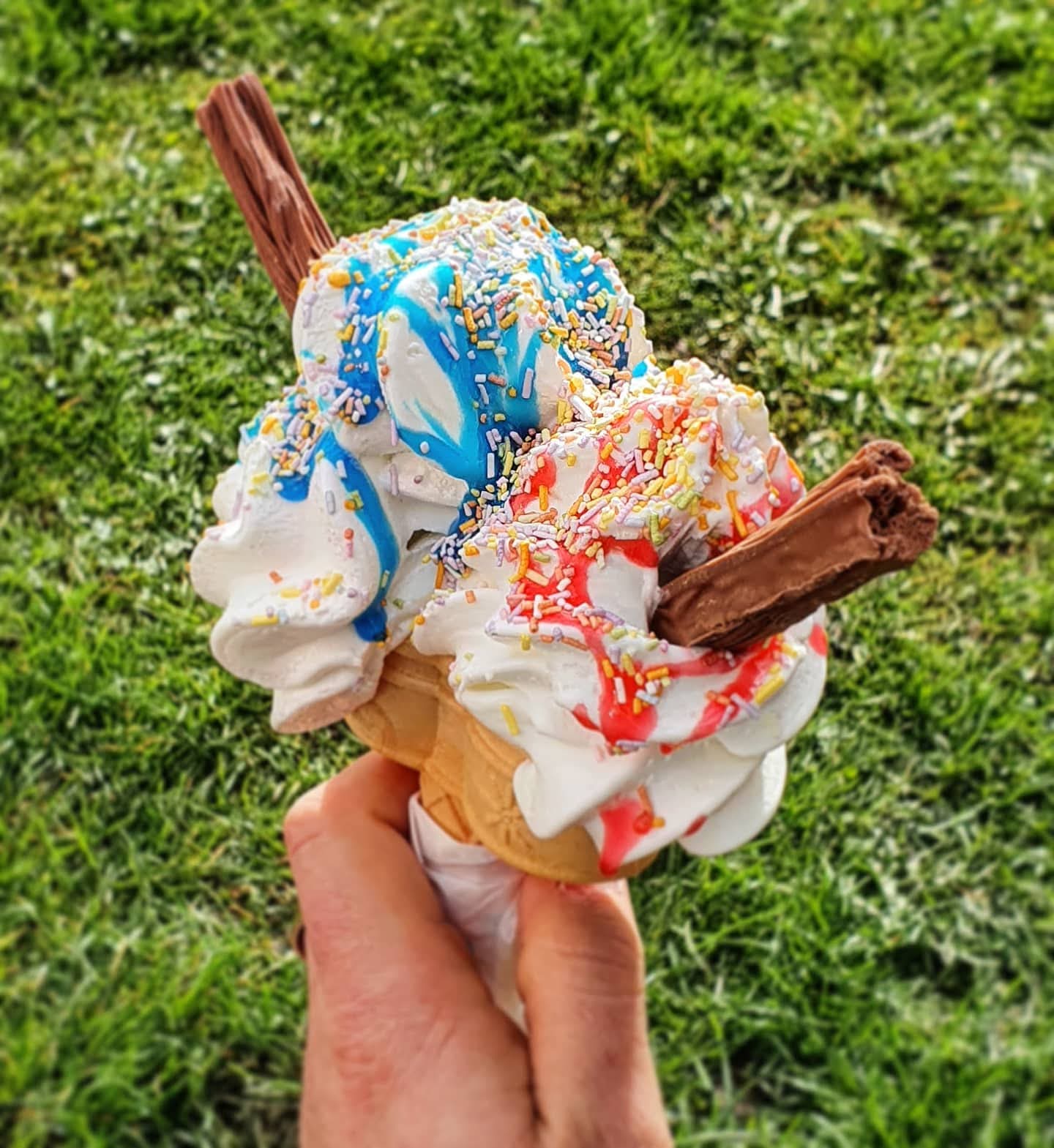 Massive twin cone with double flakes and rainbow sprinkles served outdoors